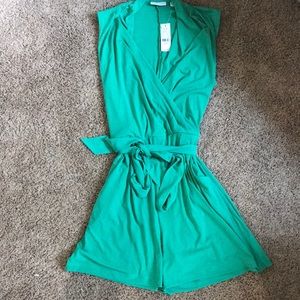 Green romper with belt and pockets